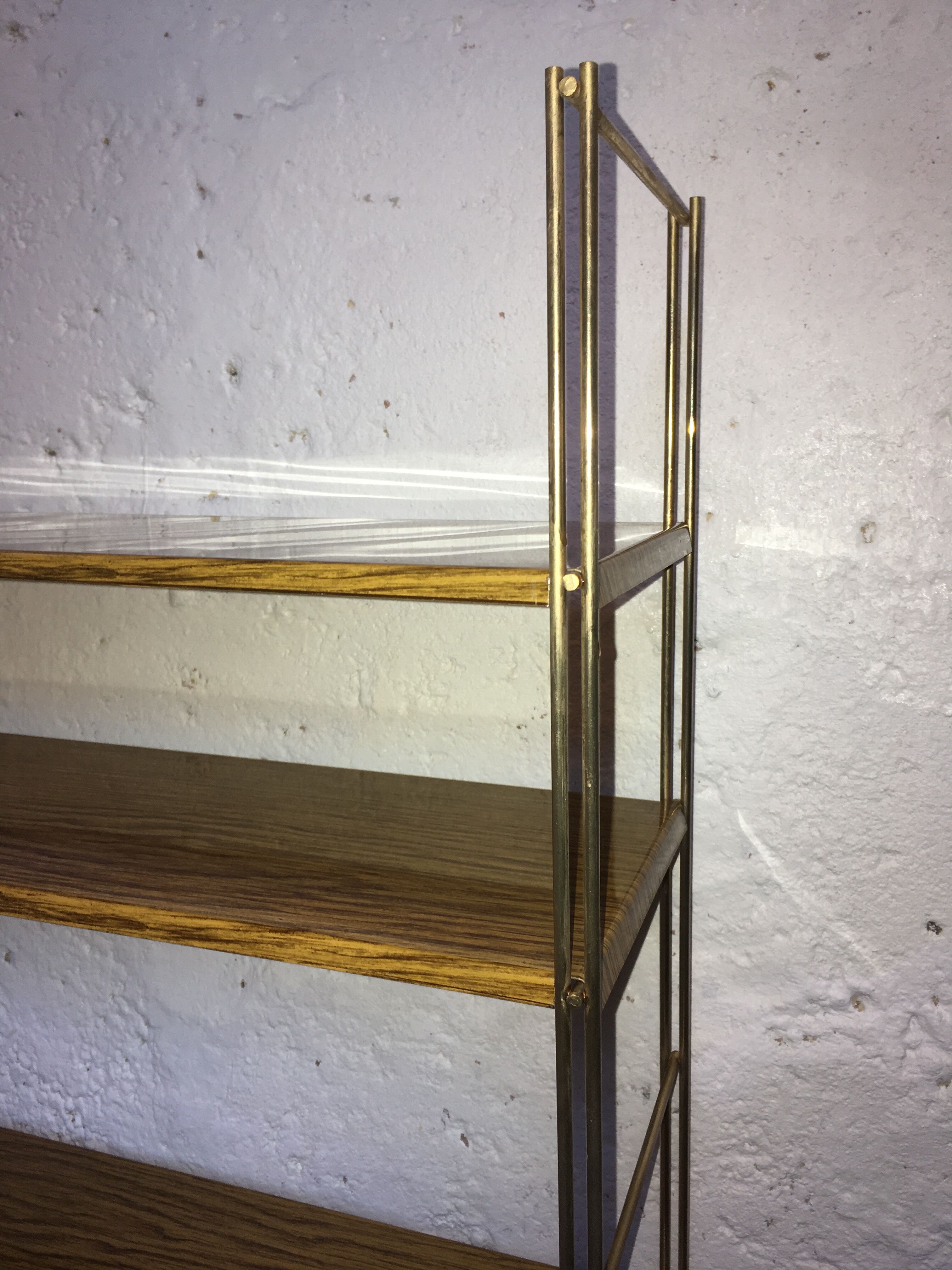set of two 1960 vintage metal thong shelves.