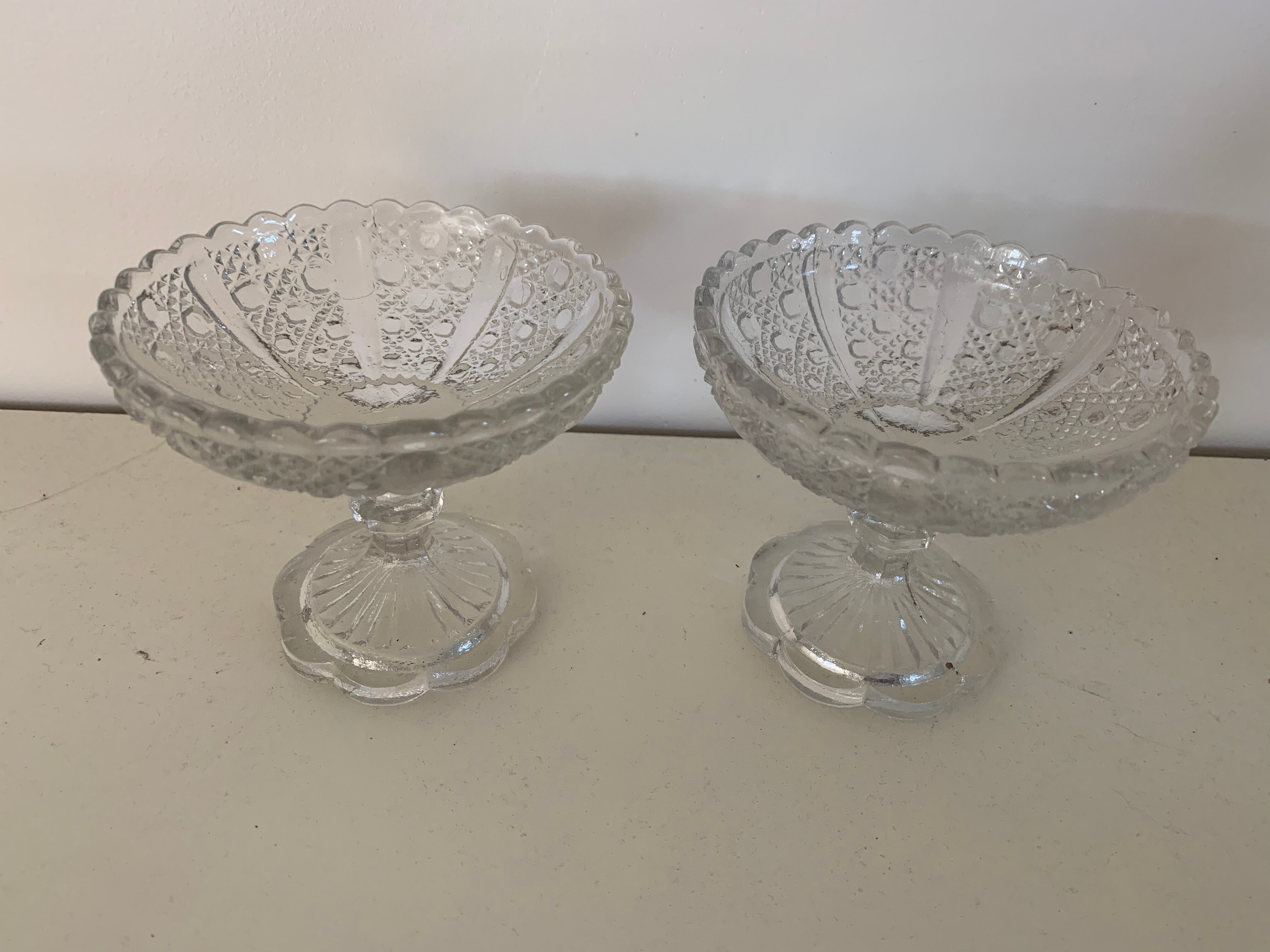 Two dredged cups in transparent glass geometric patterns in old relief