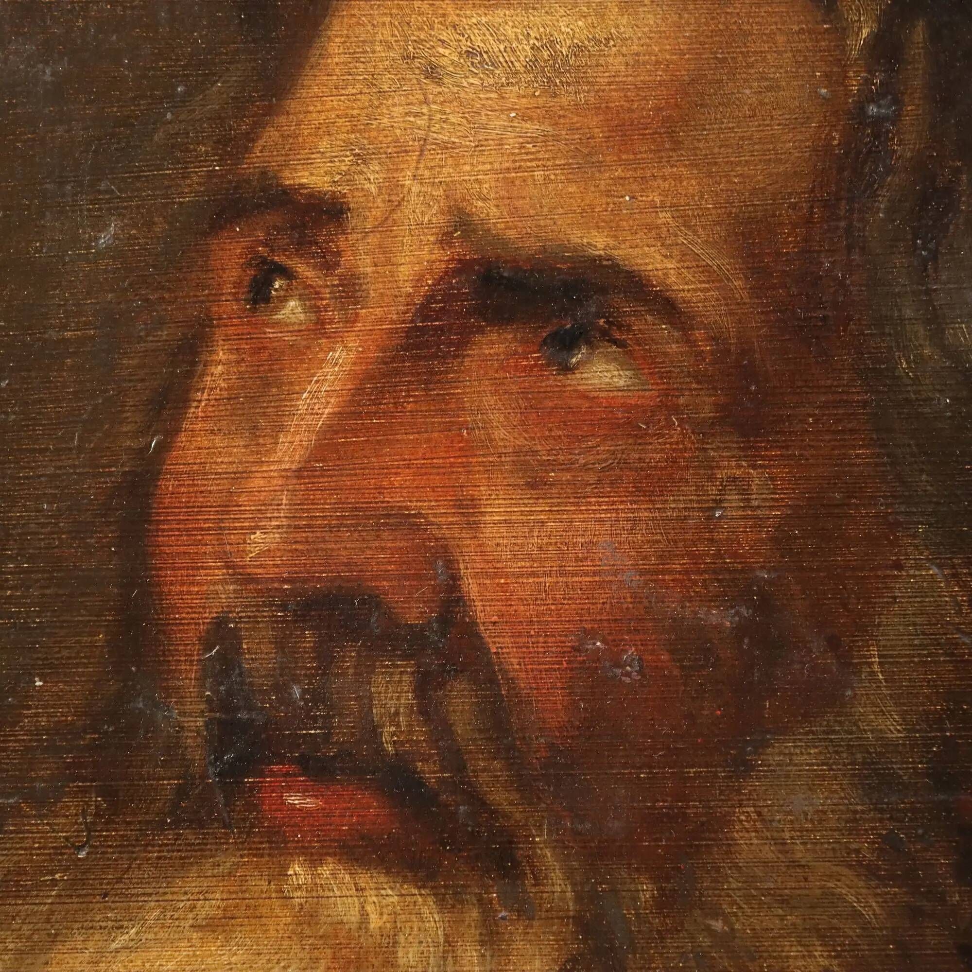Old painting of a male face in oil on cardboard from the 19th century.