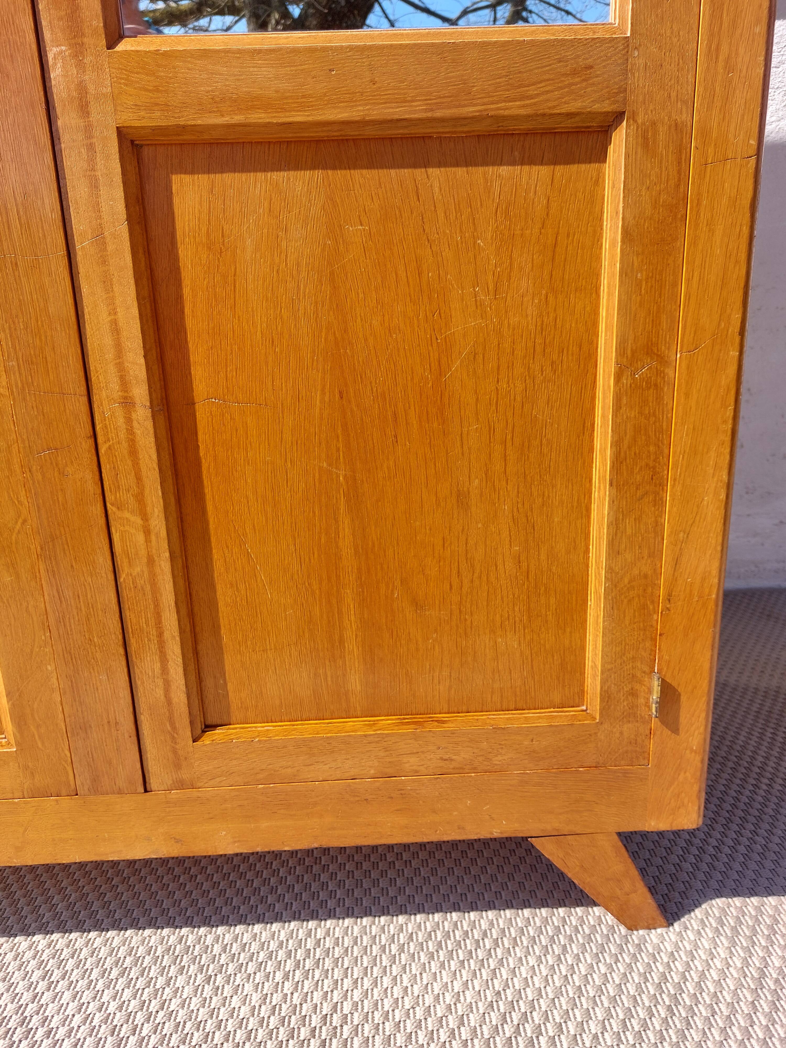 Vintage wardrobe with mirror and tapered legs.