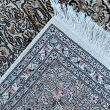Hand-knotted Persian silk rug