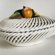 Covered basket in white woven ceramic and fruit slip.