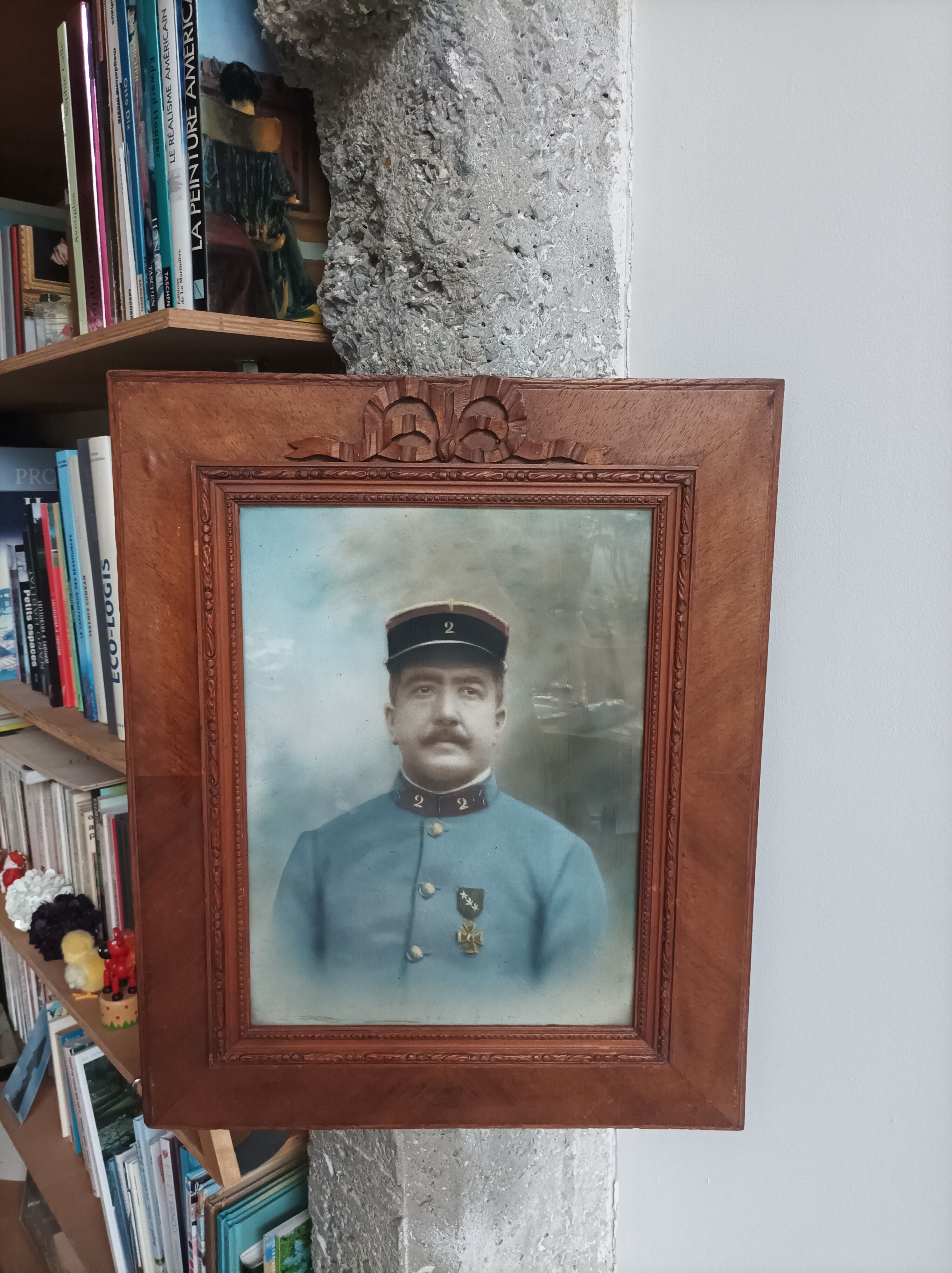 Antique wooden frame with carved portrait knot