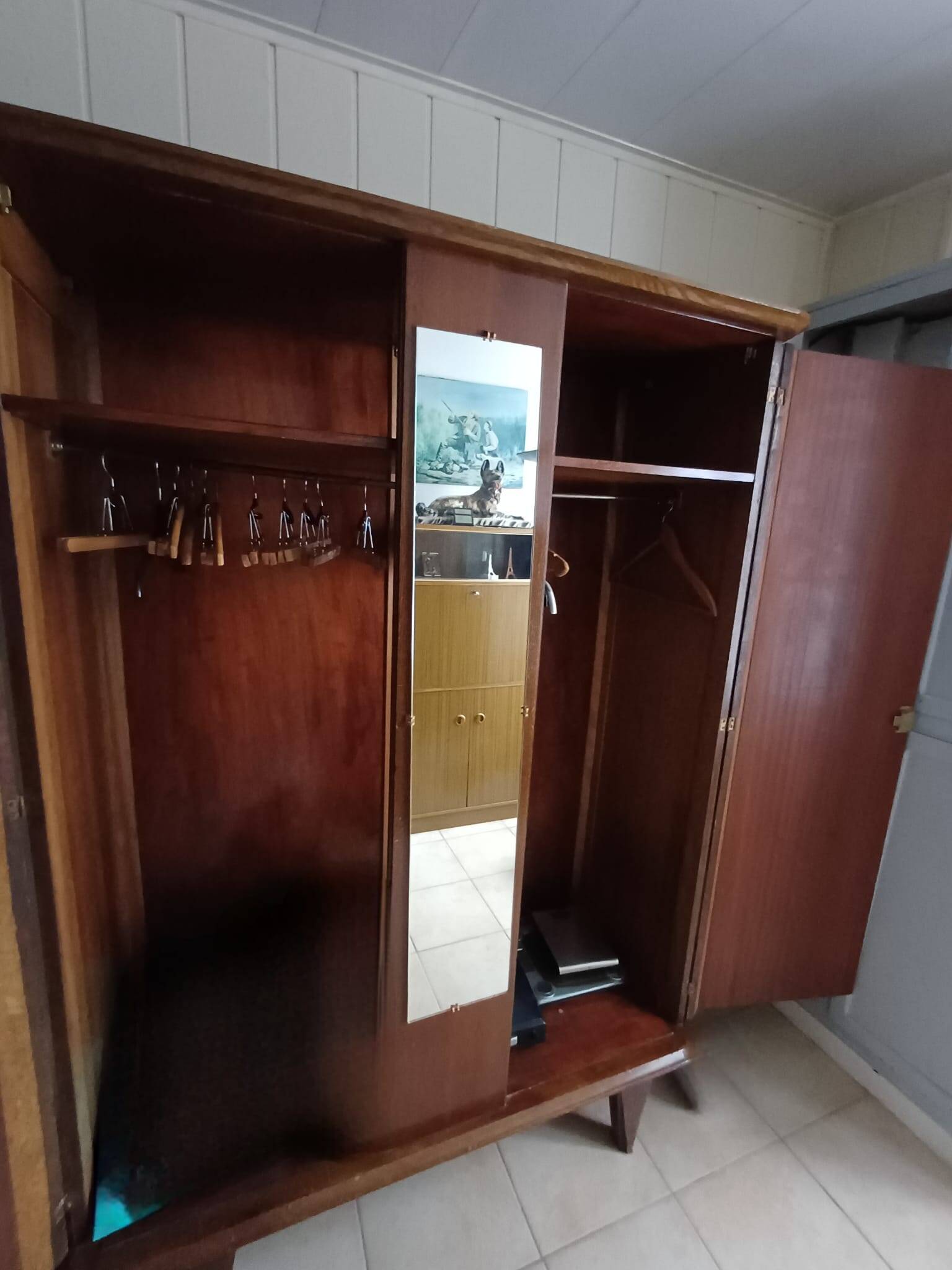 Vintage 1960s wooden wardrobe with a central mirror and tapered legs.