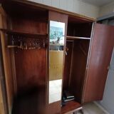 Vintage 1960s wooden wardrobe with a central mirror and tapered legs.