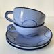 A pair of glazed ceramic cups and saucers from the 60s-70s.