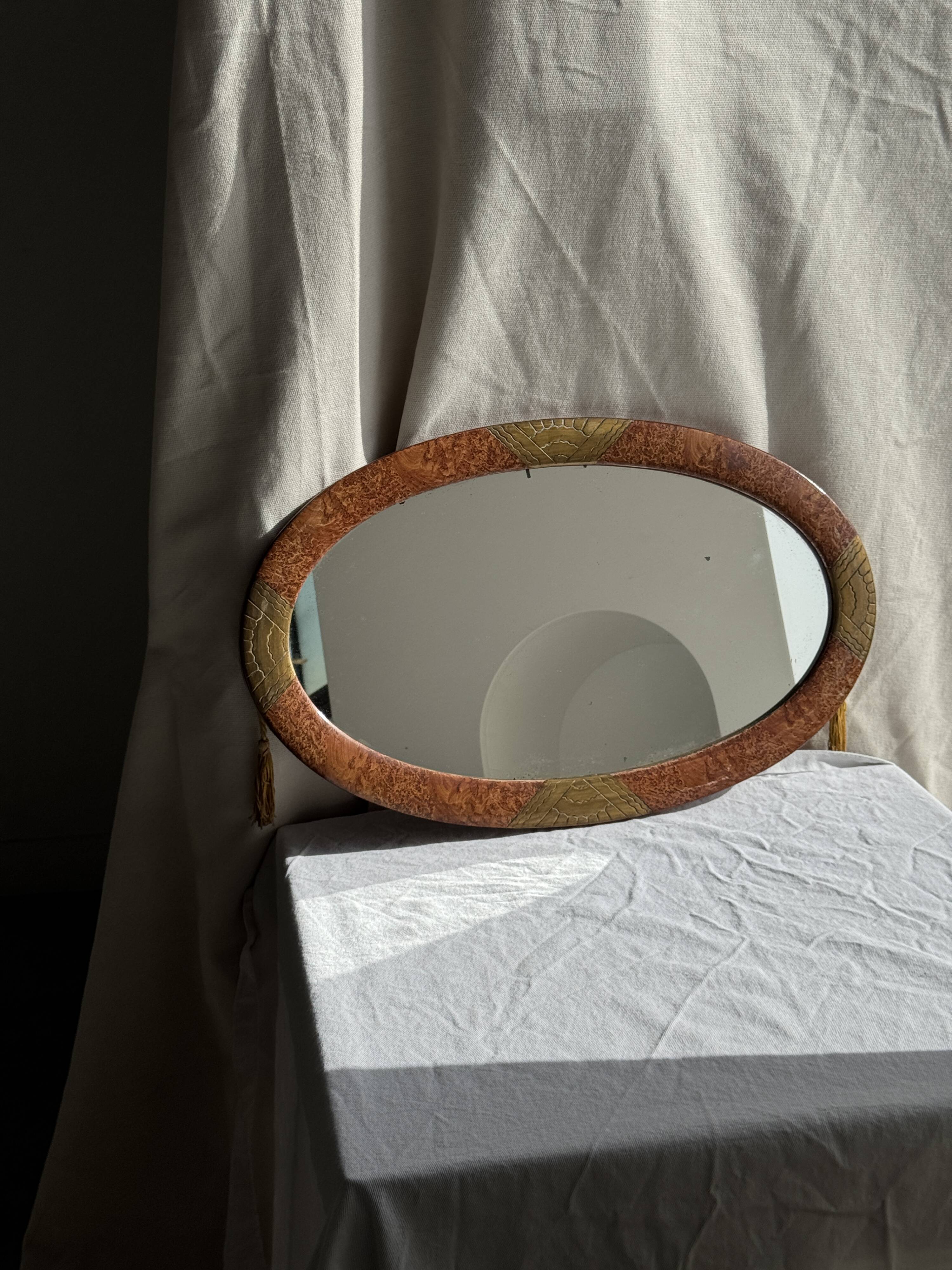 Small oval Art Deco mirror in brown and gold 33x54.
