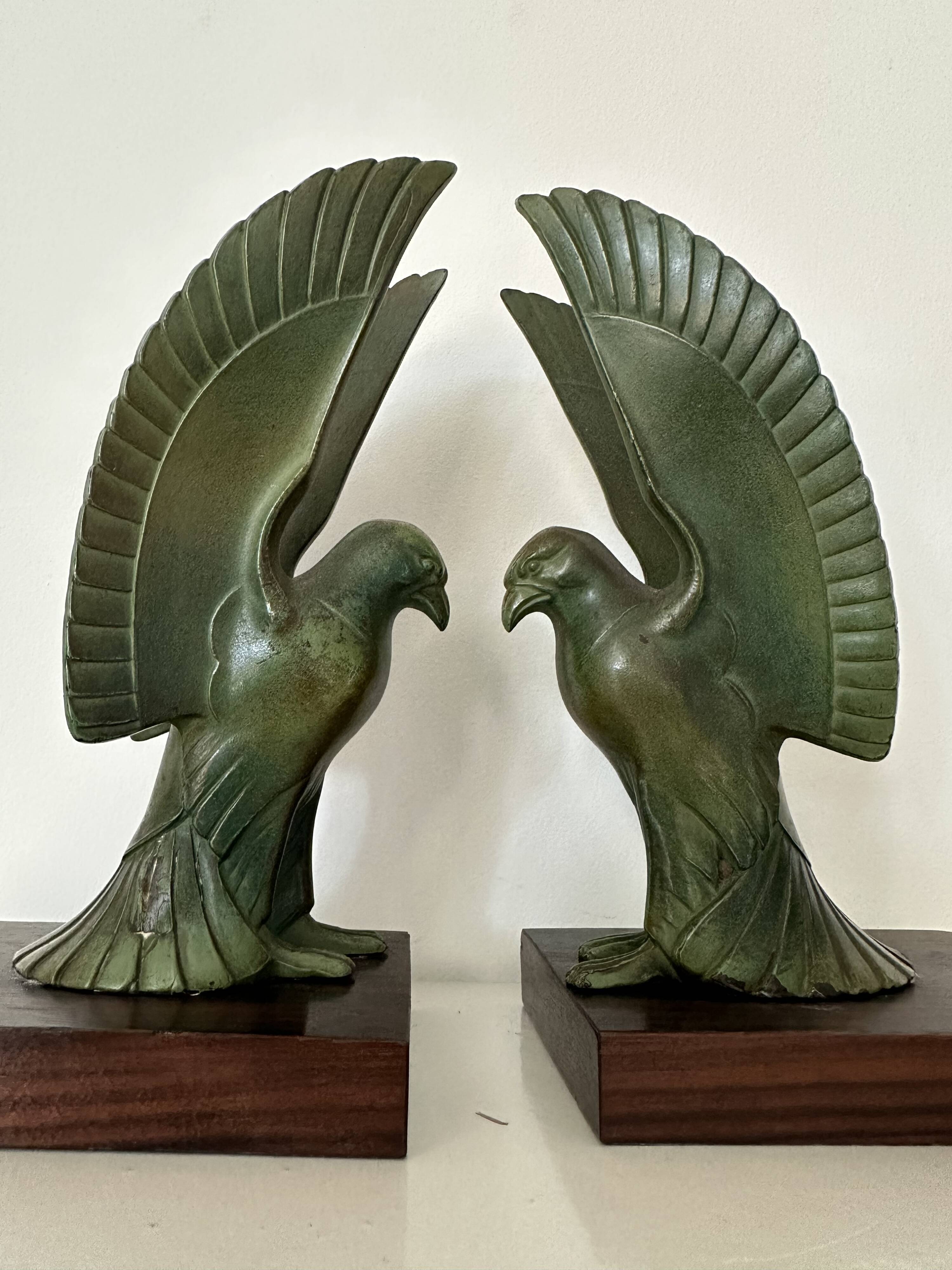 Pair of eagle bookends in green patina regula with rosewood base