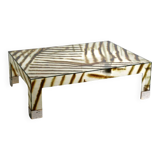 A zebra-striped plexiglass coffee table