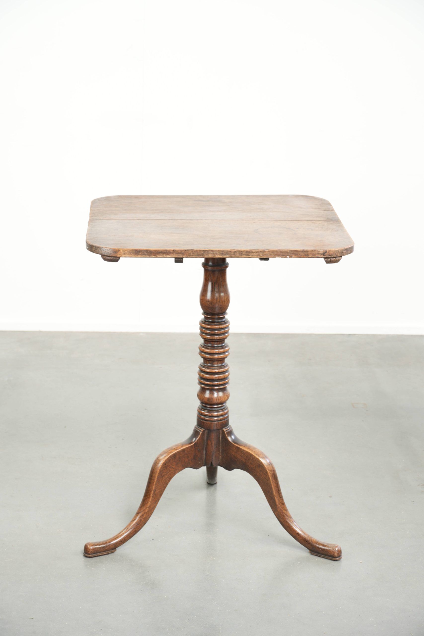 Antique English oak tilt top table from the 19th century in a unique shape