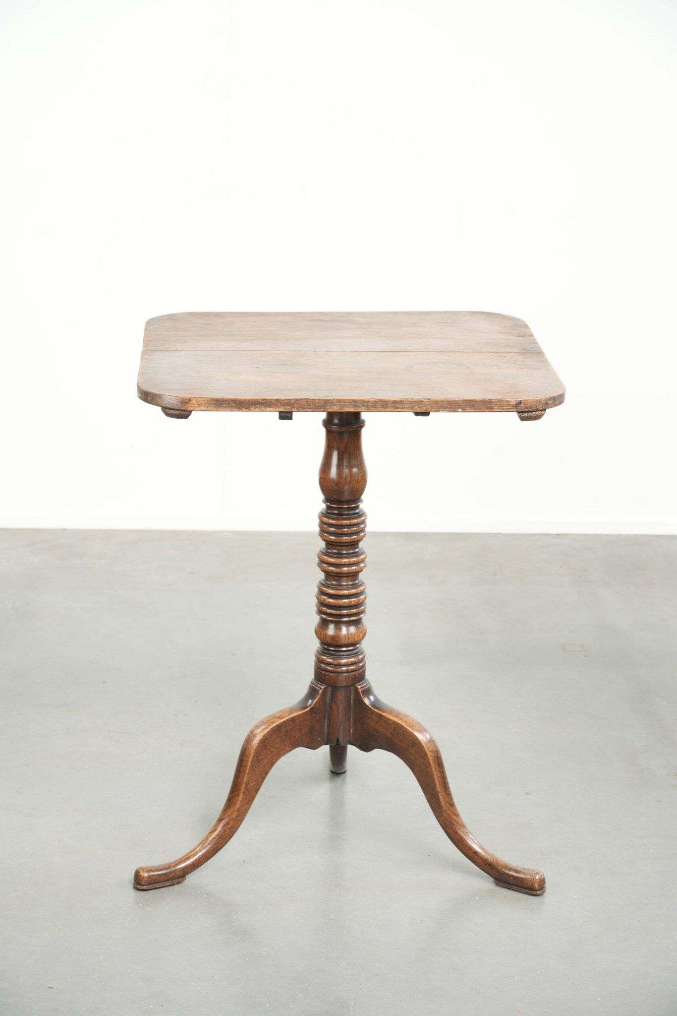 Antique English oak tilt top table from the 19th century in a unique shape