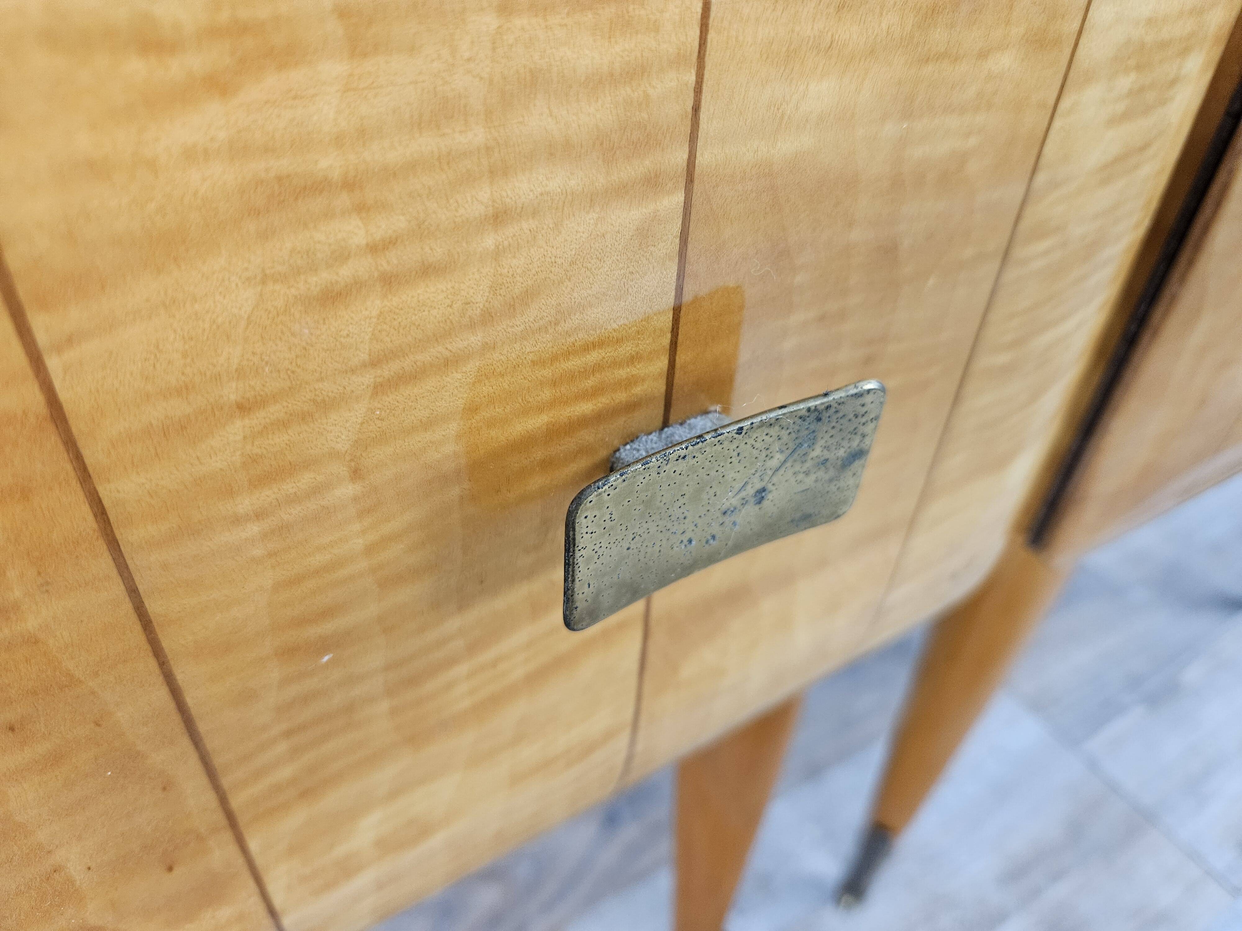 Mid-century nightstands in maple, brass, and glass