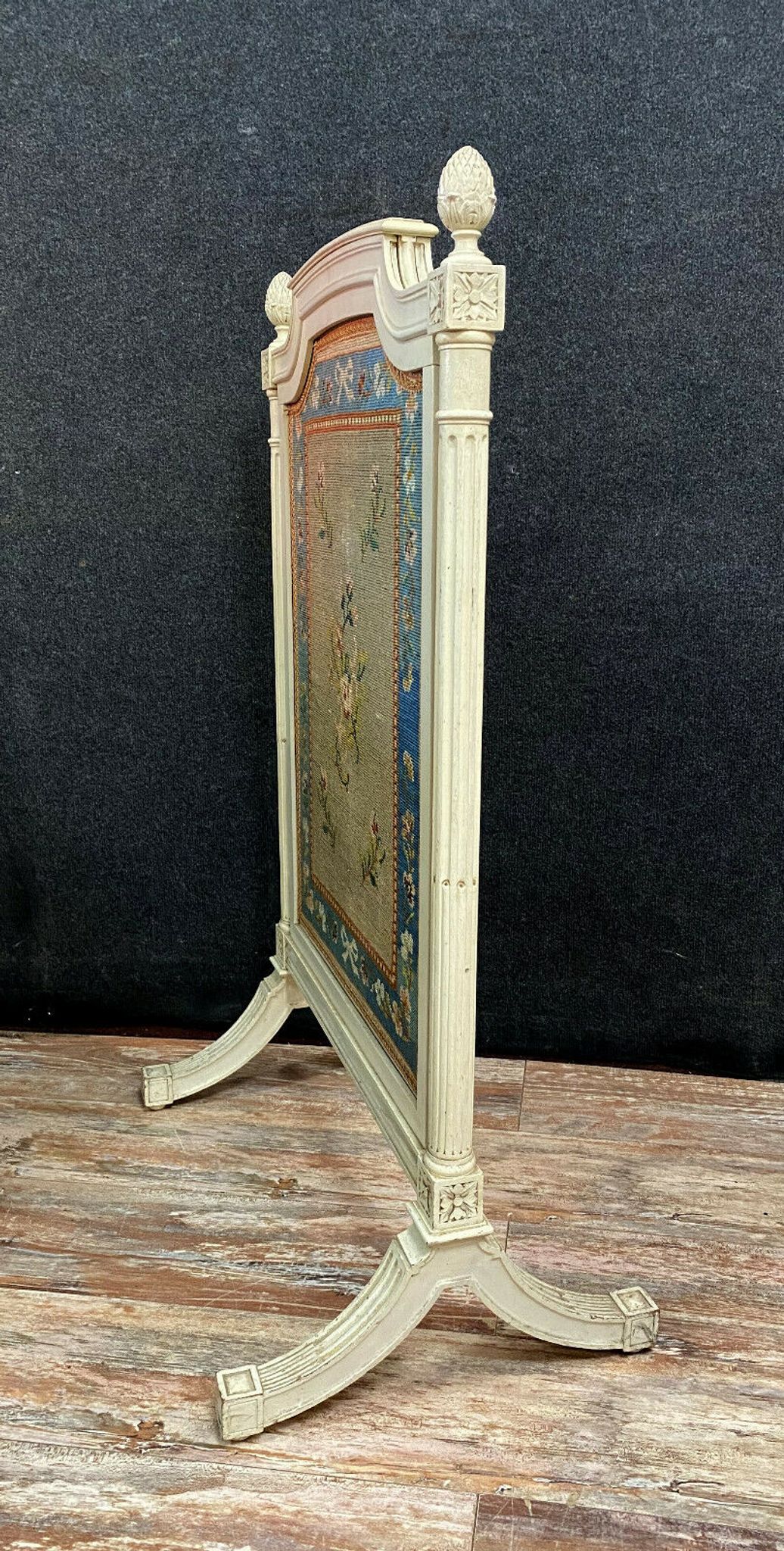 Front of Louis XVI fireplace in laqué wood and fabric has floral decorations