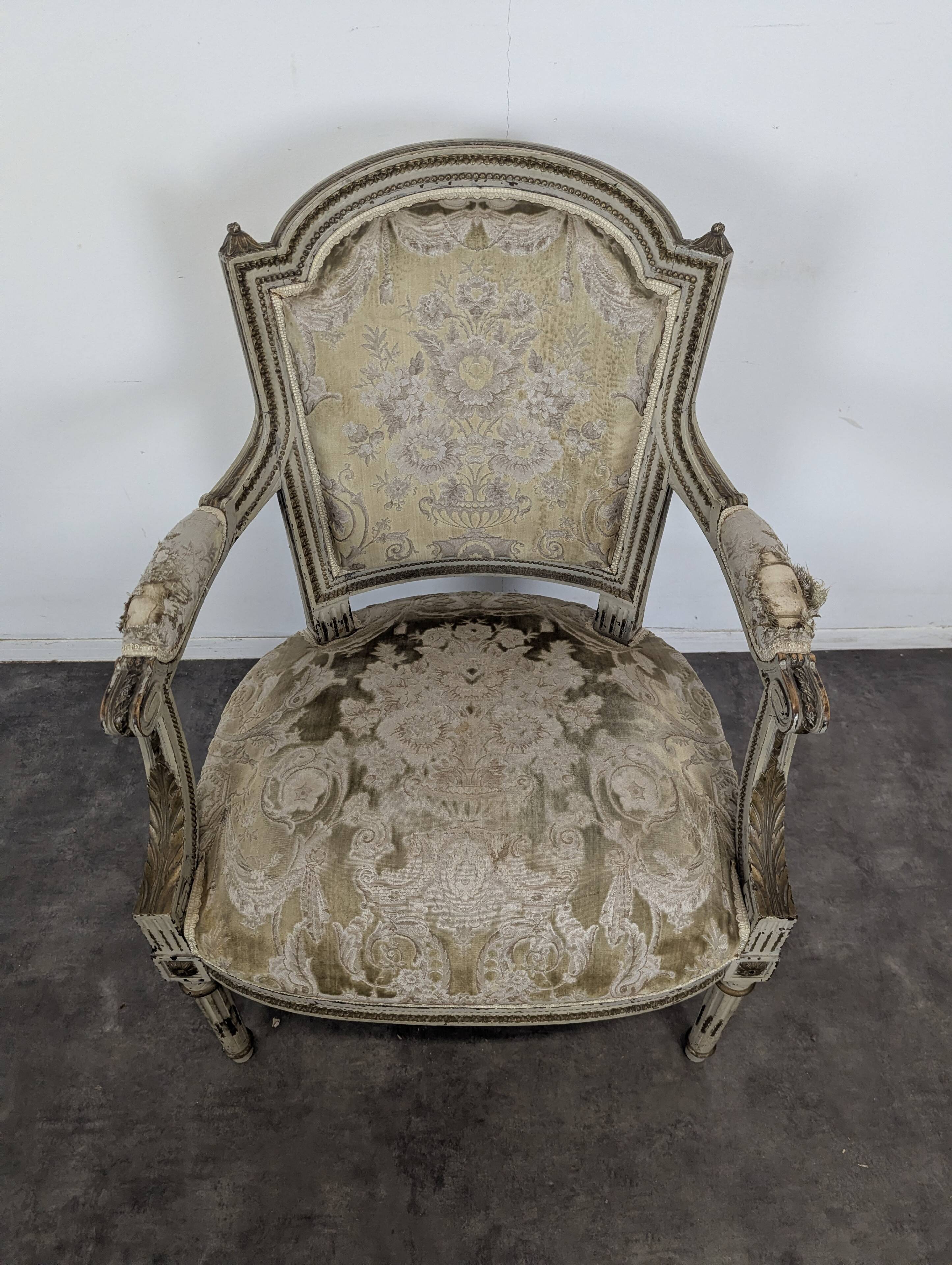 Cream lacquered Louis XVI style cabriolet salon with gold highlights.