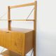Wall shelf library with vintage light wood secretary bar