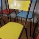 8 canteen chairs, yellow, blue, and red Formica with metal tubing from the 1950s-60s.