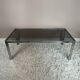Table basse chromée et verre fumé années 70