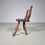 Rustic Wabi-Sabi style accent chair in dark curved hardwood, 1900s.