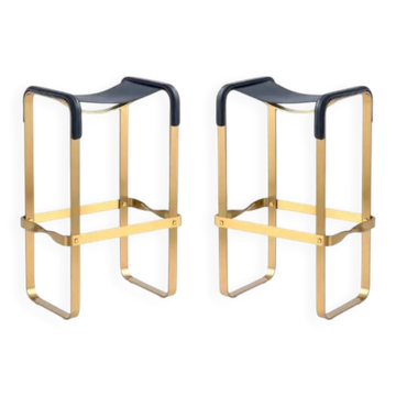 Pair of blue metal and brass stools without a backrest.