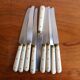 Set of 9 vintage cream table knives