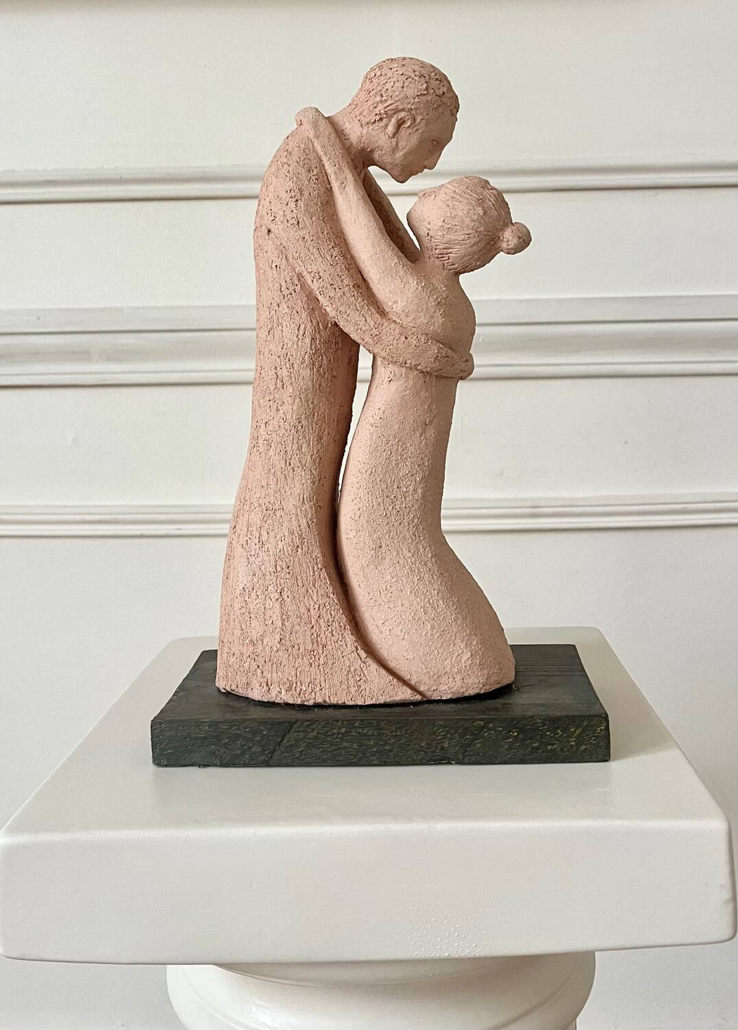 Sculpture of a couple entwined in grog clay.