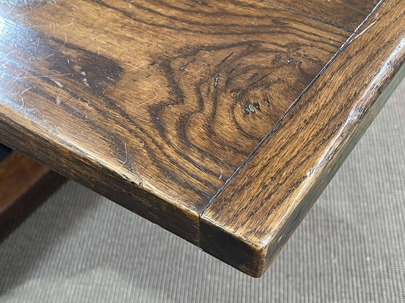 English monastery table with extensions from the late 19th century in elm and oak.