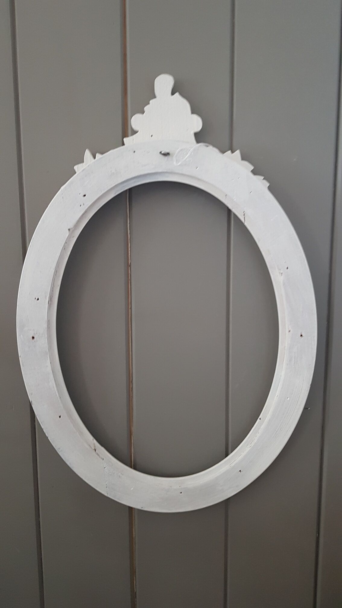Old oval frame patinated white