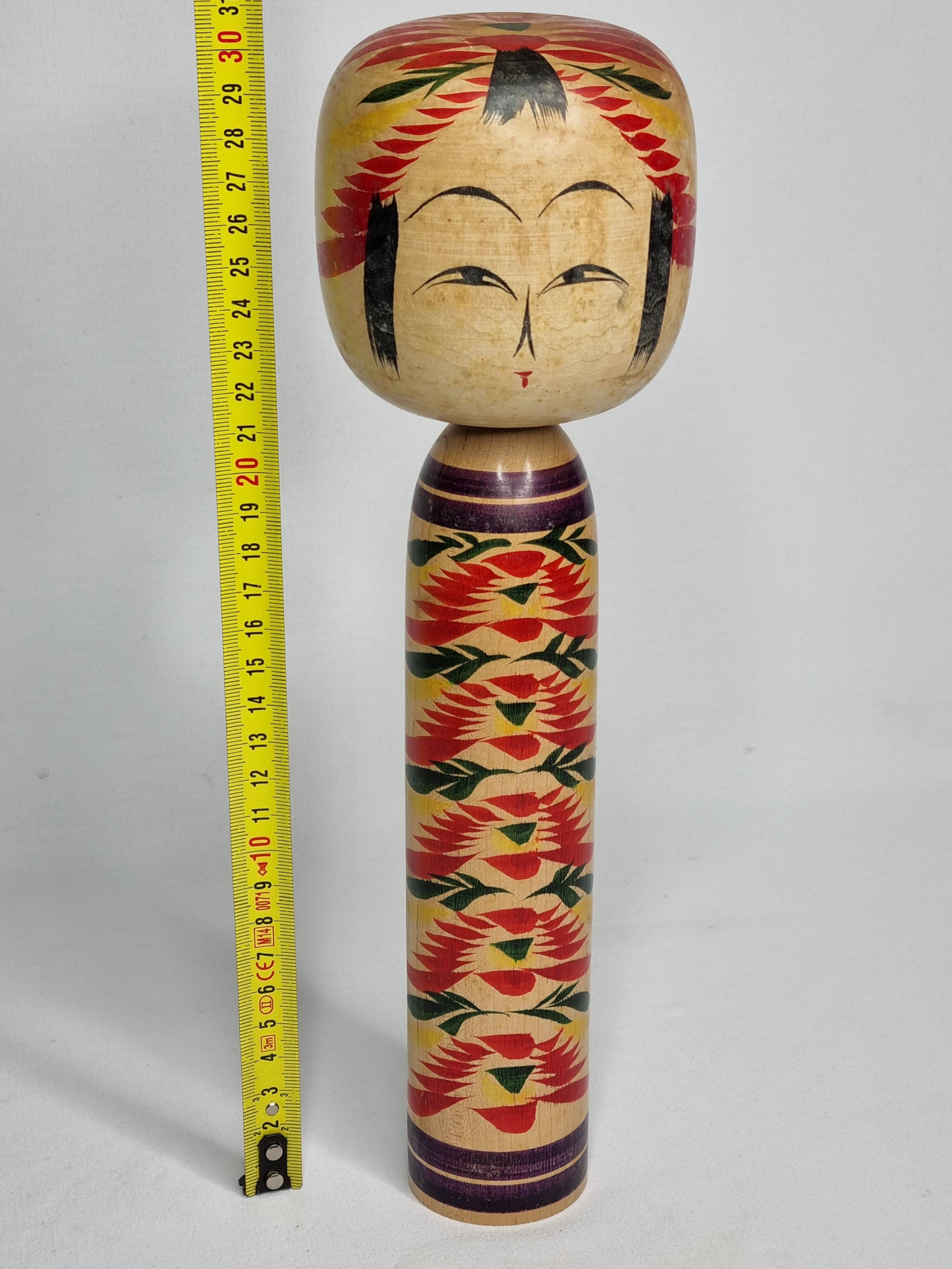 Japanese Kokeshi doll dated 1986, signed and numbered, hand-painted multi-colored floral decoration,