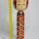 Japanese Kokeshi doll dated 1986, signed and numbered, hand-painted multi-colored floral decoration,