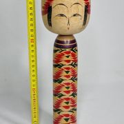 Japanese Kokeshi doll dated 1986, signed and numbered, hand-painted multi-colored floral decoration,