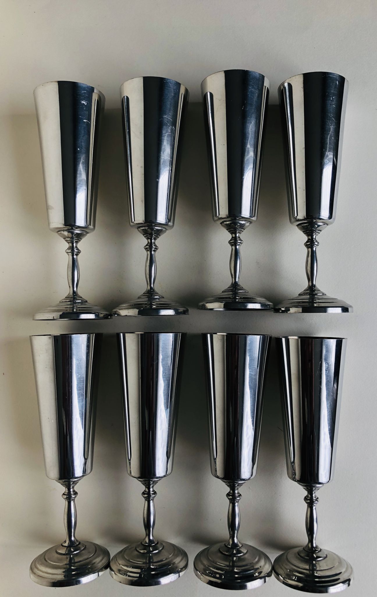 Set of eight silver metal flutes