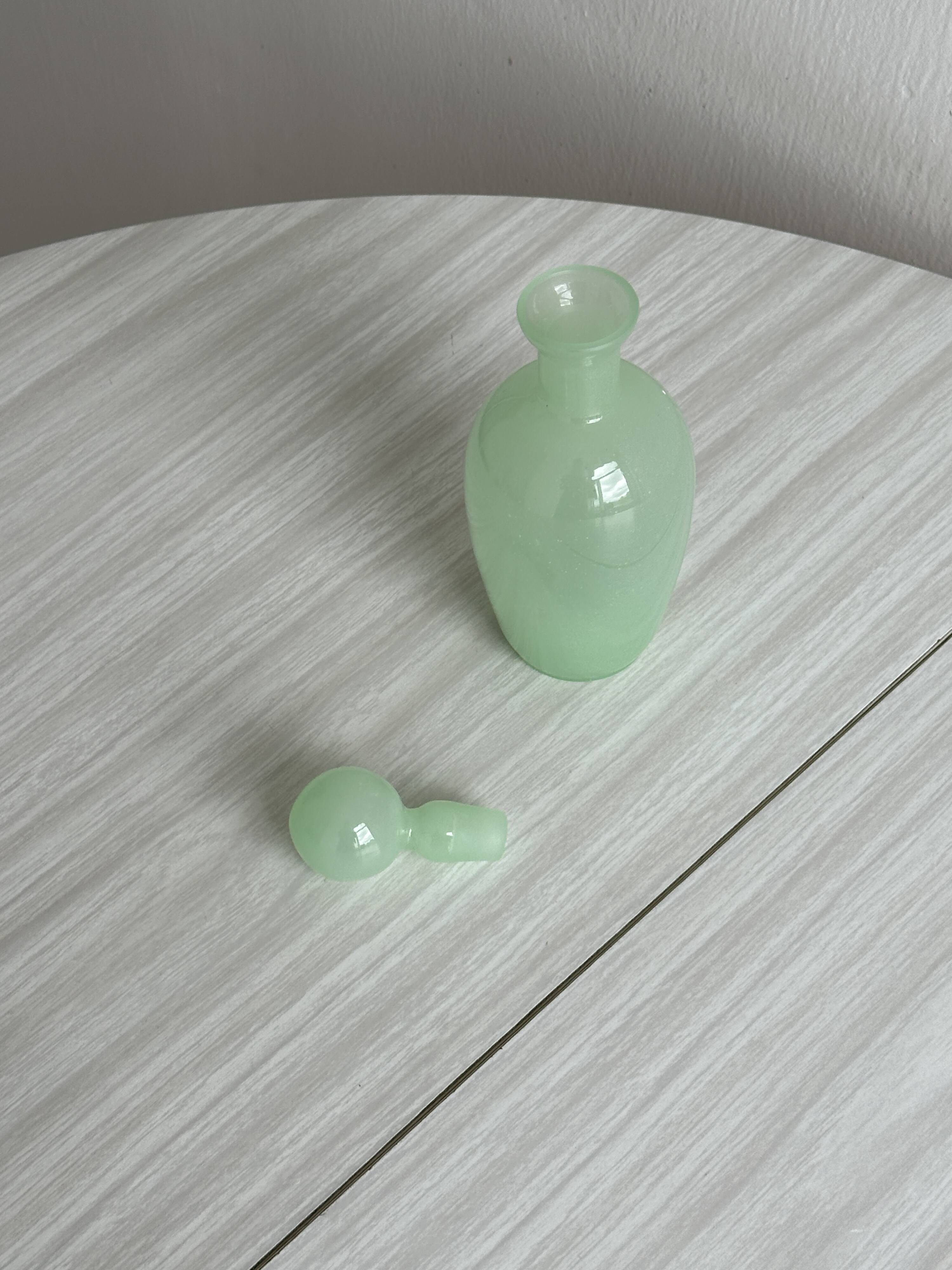 Opaque light green glass vial