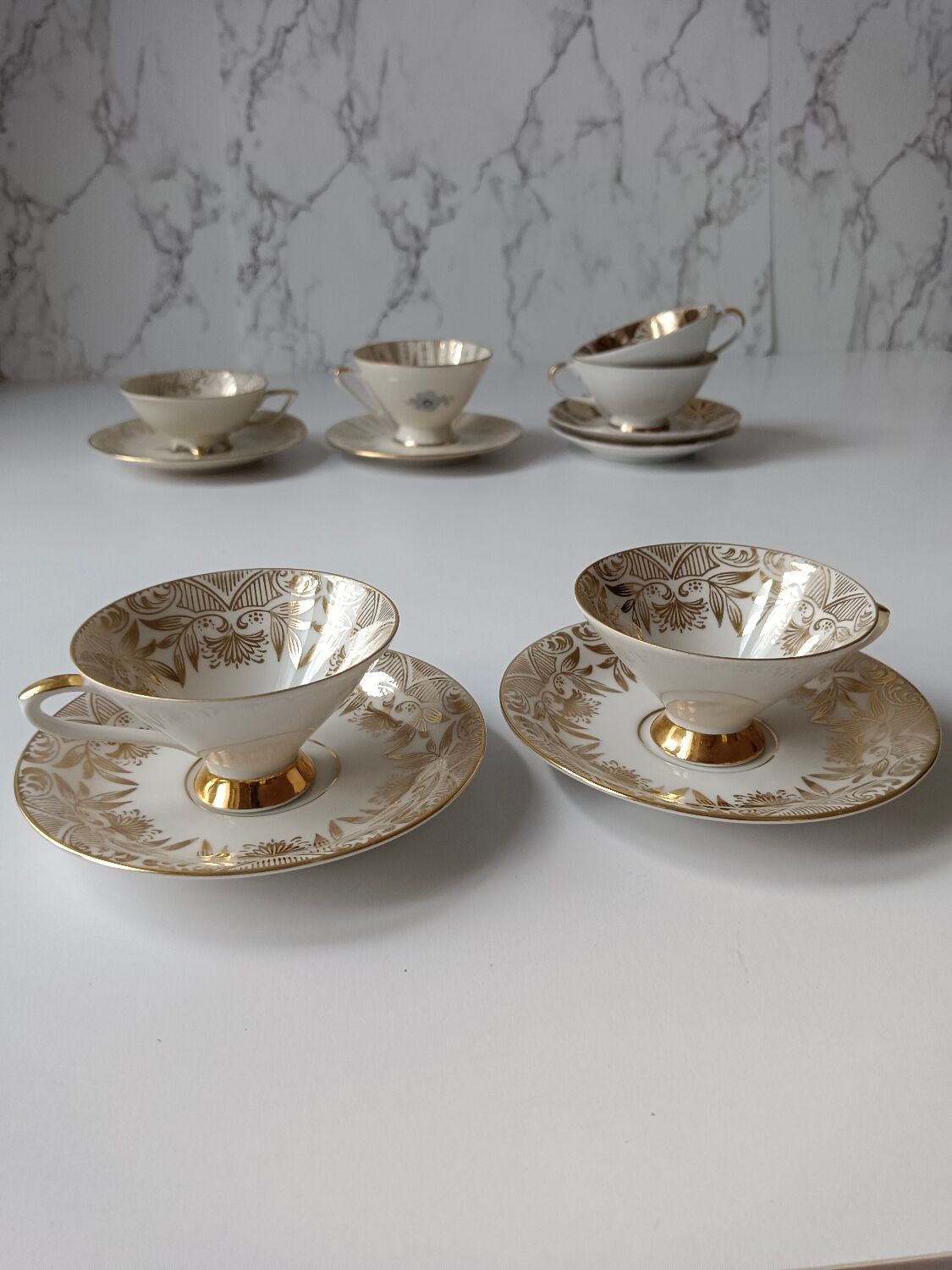 Set of mismatched fine porcelain cups signed with saucer