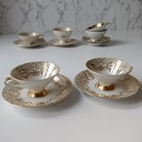 Set of mismatched fine porcelain cups signed with saucer