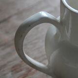 Old pitcher in white earthenware