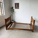 Brutalist style bed with chain and straw