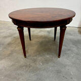 Extendable mahogany round table in Louis XVI style