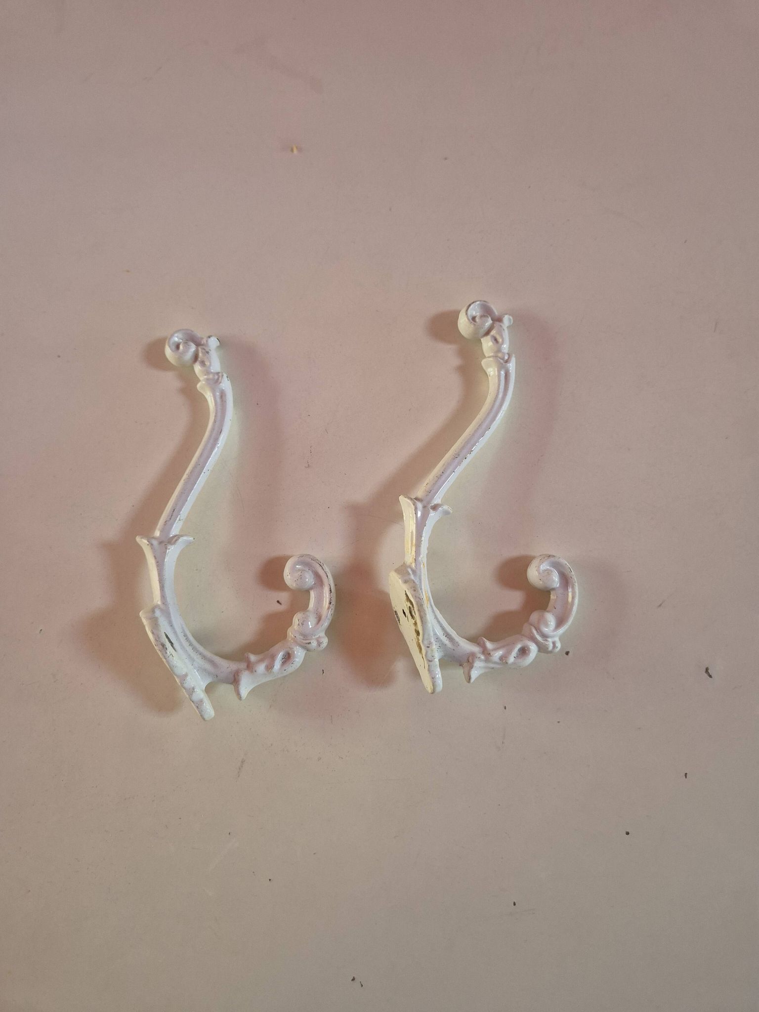 set of 2 vintage white cast iron hooks, small paint chips from the year