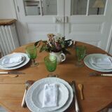 Walnut table with raised flaps, base on verdigris casters.