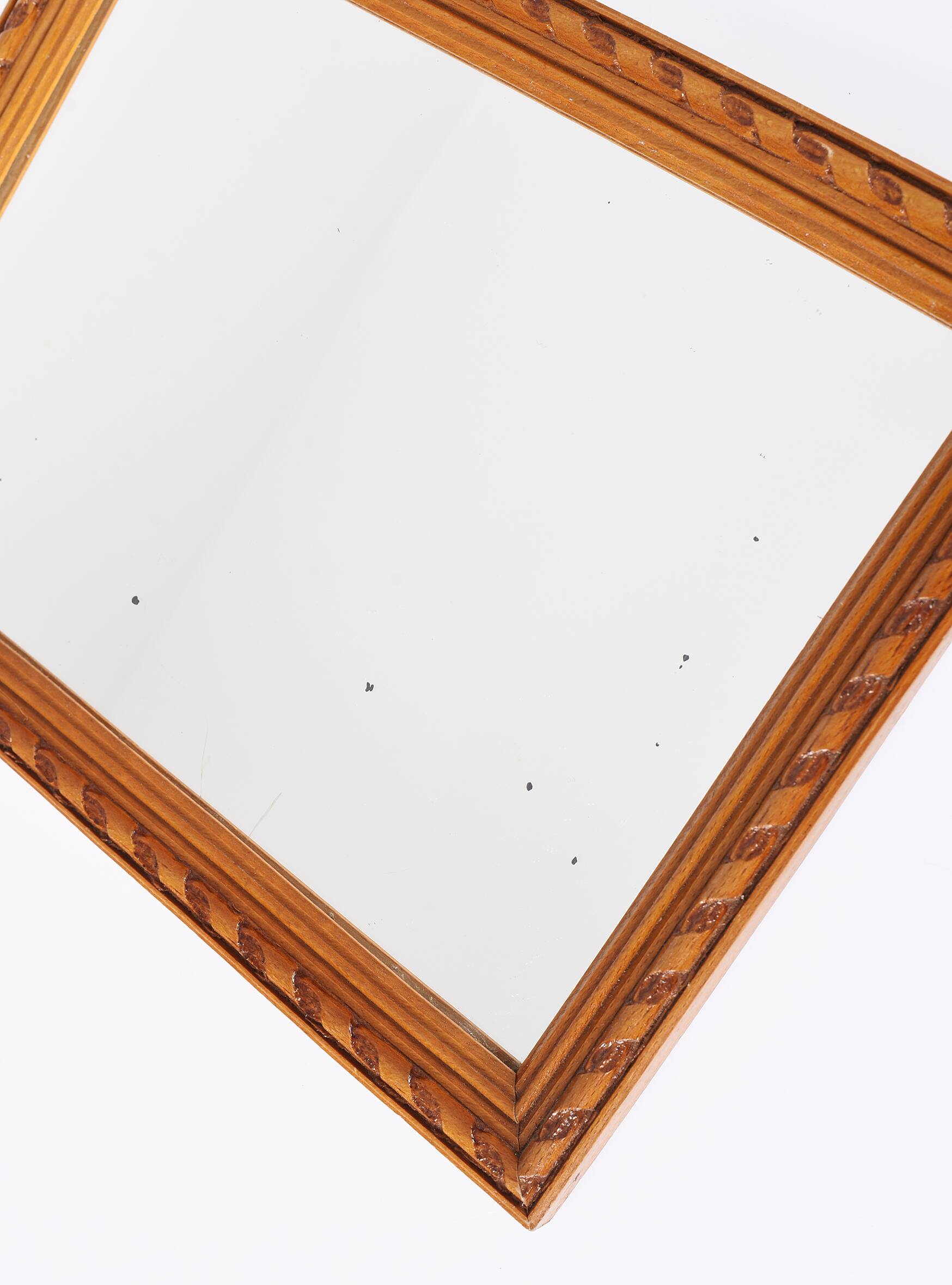 Small old wooden mirror with carved frame