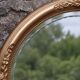 Miroir ovale vintage doré à décor floral et verre biseauté – 58 × 48 cm