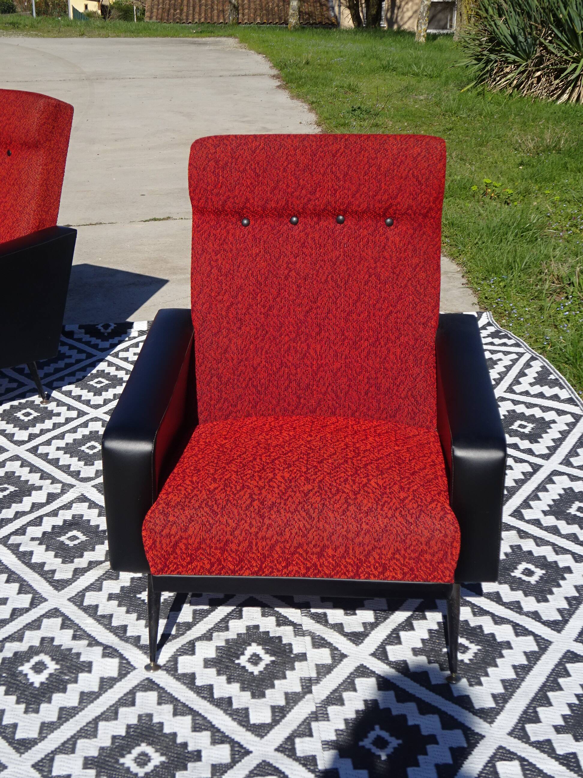 Vintage armchairs in red and black faux leather, the pair.