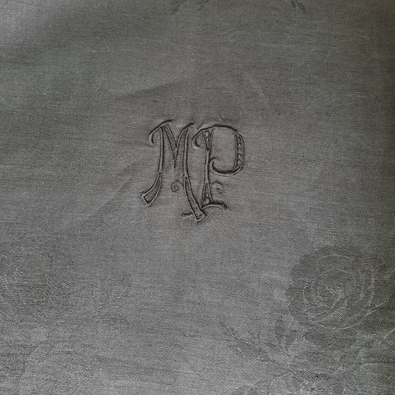 Old damask tablecloth with monogram