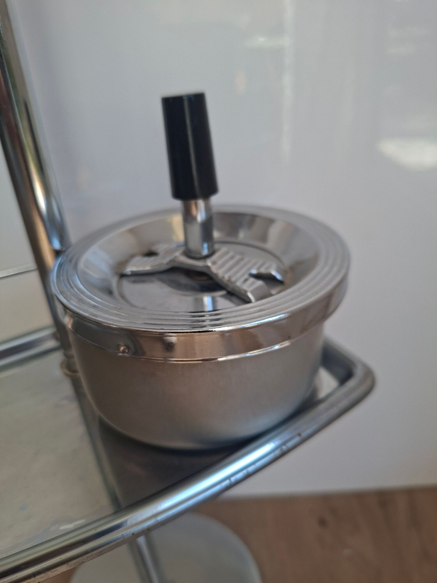 Vintage chrome metal floor ashtray with integrated tray.