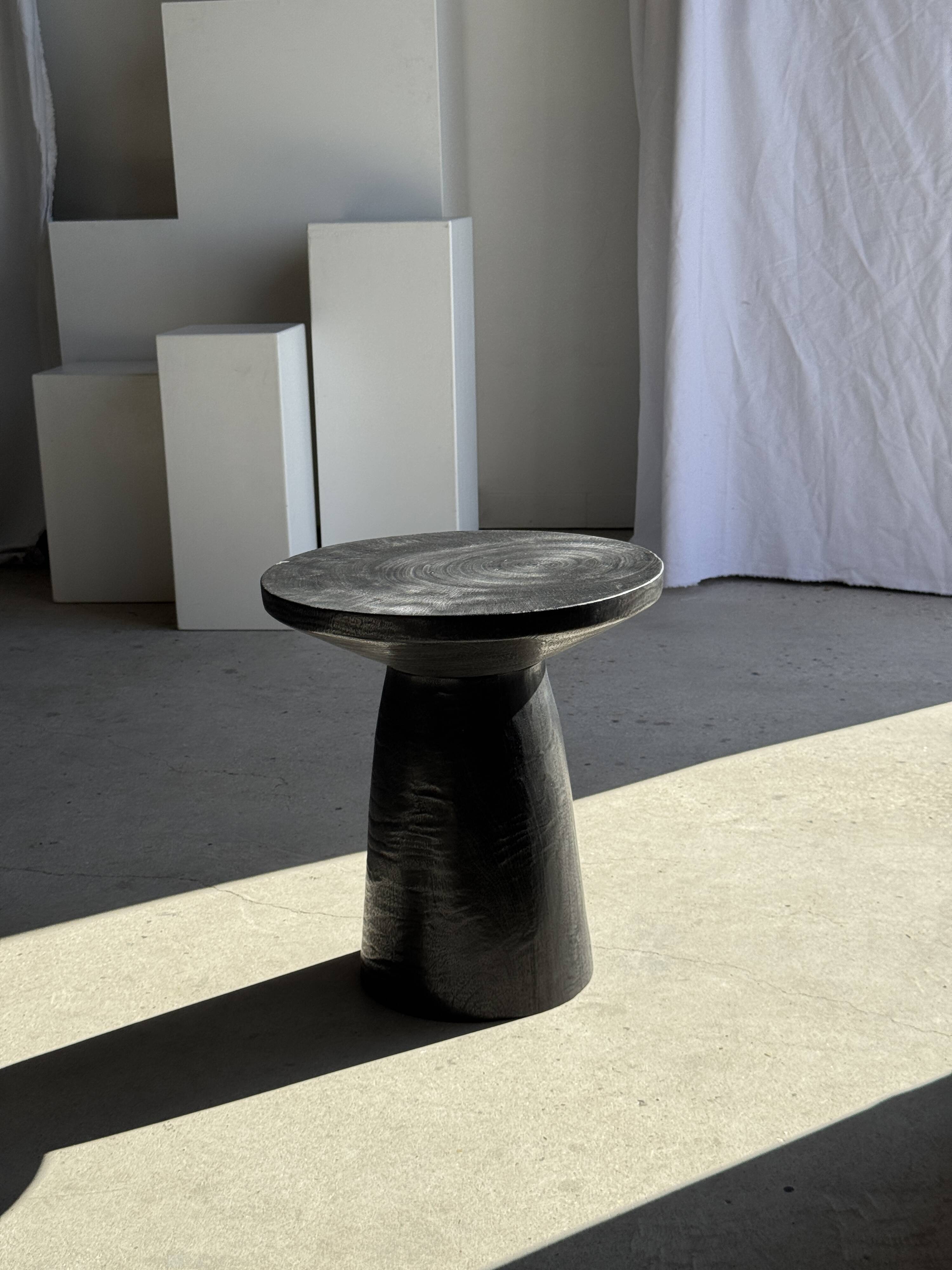 Black solid mango side table (monoxyle) with conical legs