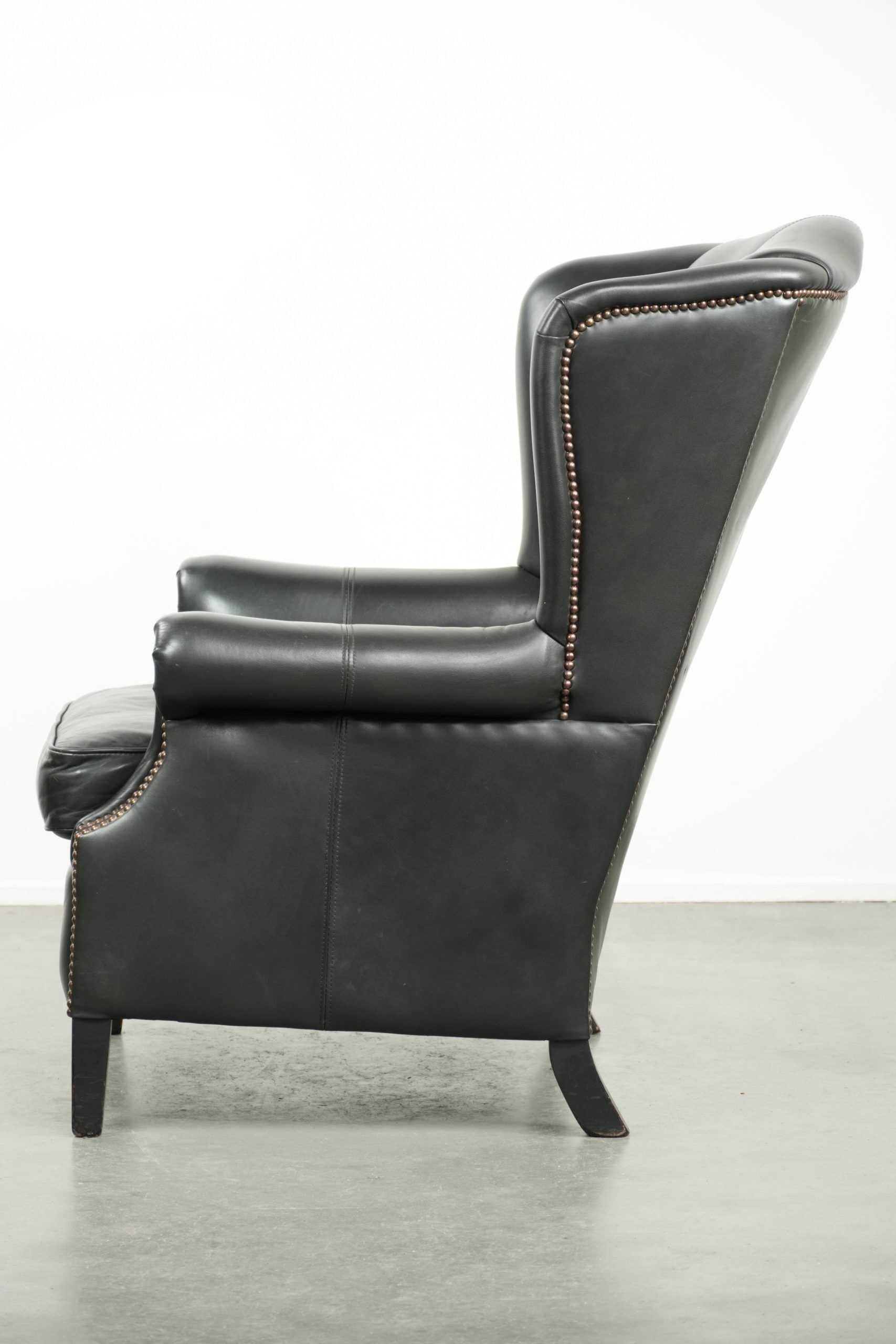 Black cowhide wingback armchair in classic English style