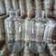 2 large antique transparent glass bottles