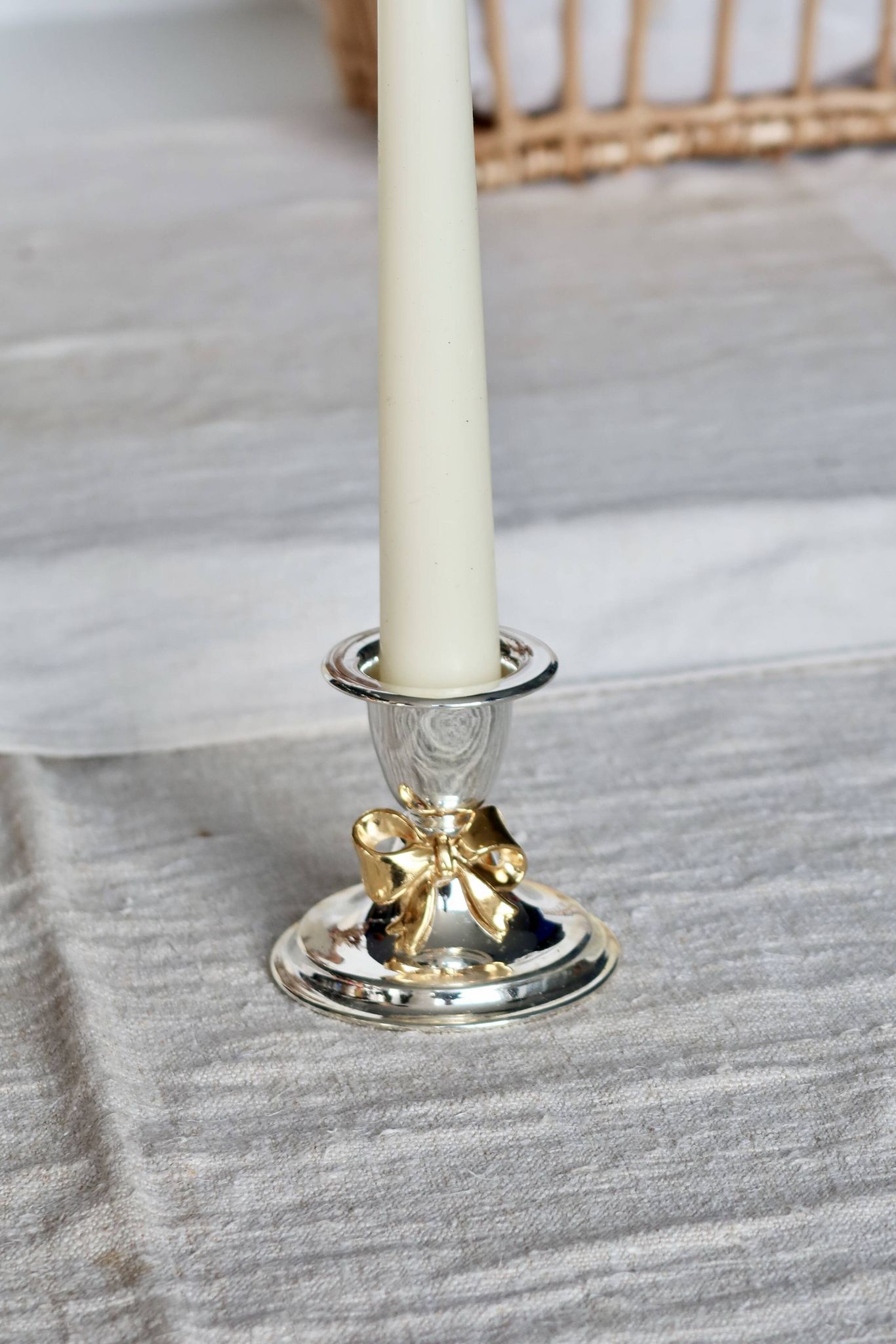 Small vintage silver-plated metal candlestick with a gold bow