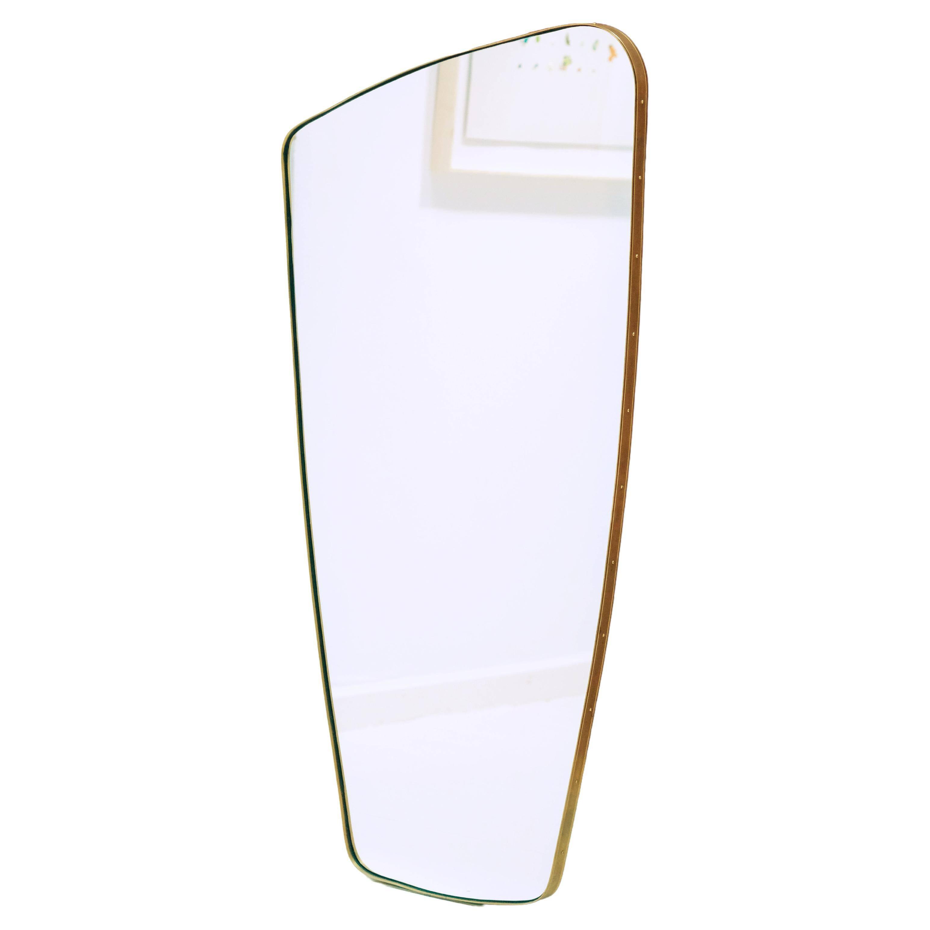 Contemporary rectangular mirror with rounded edges and embossed brass frame.