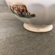 Old bowl decorated with a farmer and her cow